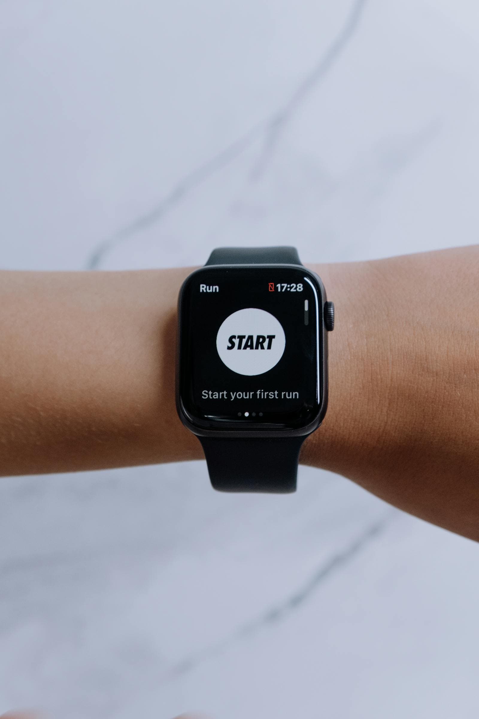 Smartwatch displaying a running app with workout metrics on screen