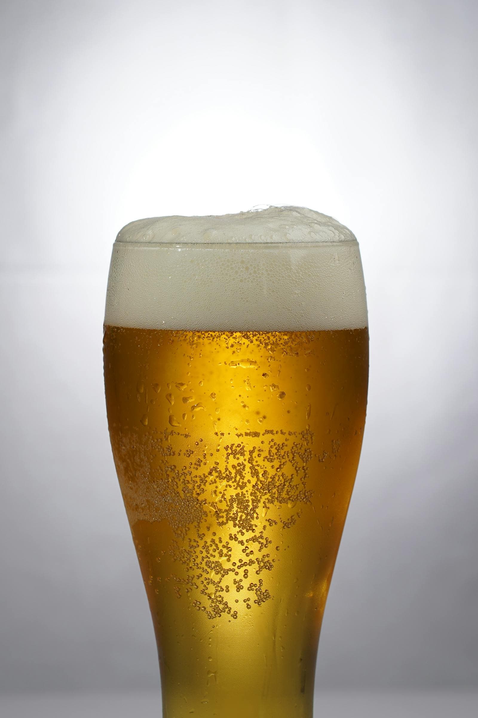 A frosty glass of light beer with foam — exploring lower-calorie options